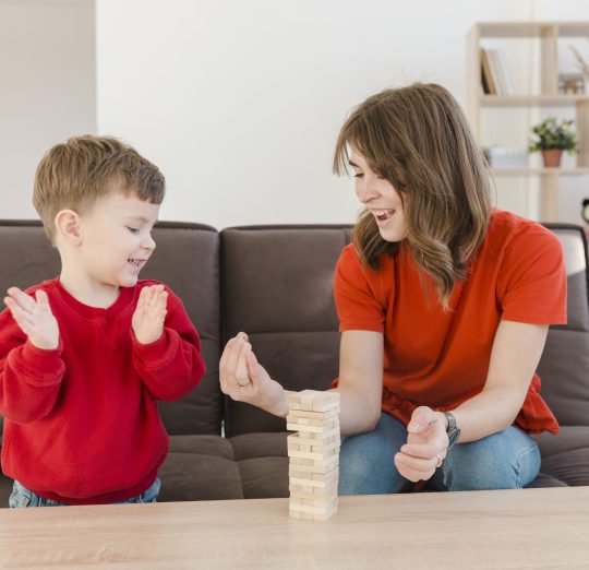 little-boy-playing-janga-with-his-mom